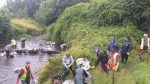 Volunteers form human chain to transport 135  bags of rubbish