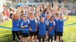Children cheer for new running track and pitch