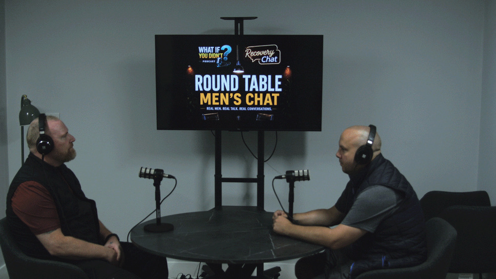 Around the table, men are talking and people are listening