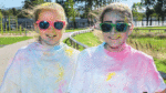 People covered in purple take part in Connect4 Colour Run